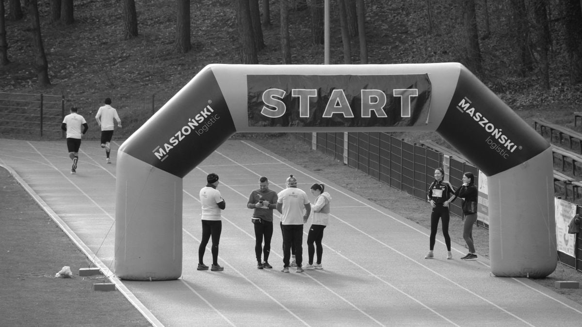 Athletes gather at the start line of a marathon, ready to begin the race.